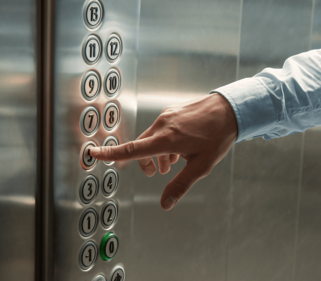 Hand Pressing An Elevator Call Button