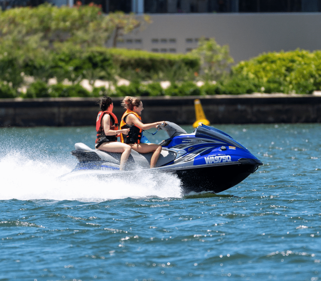 Two People Riding A Jet Ski On The Water
