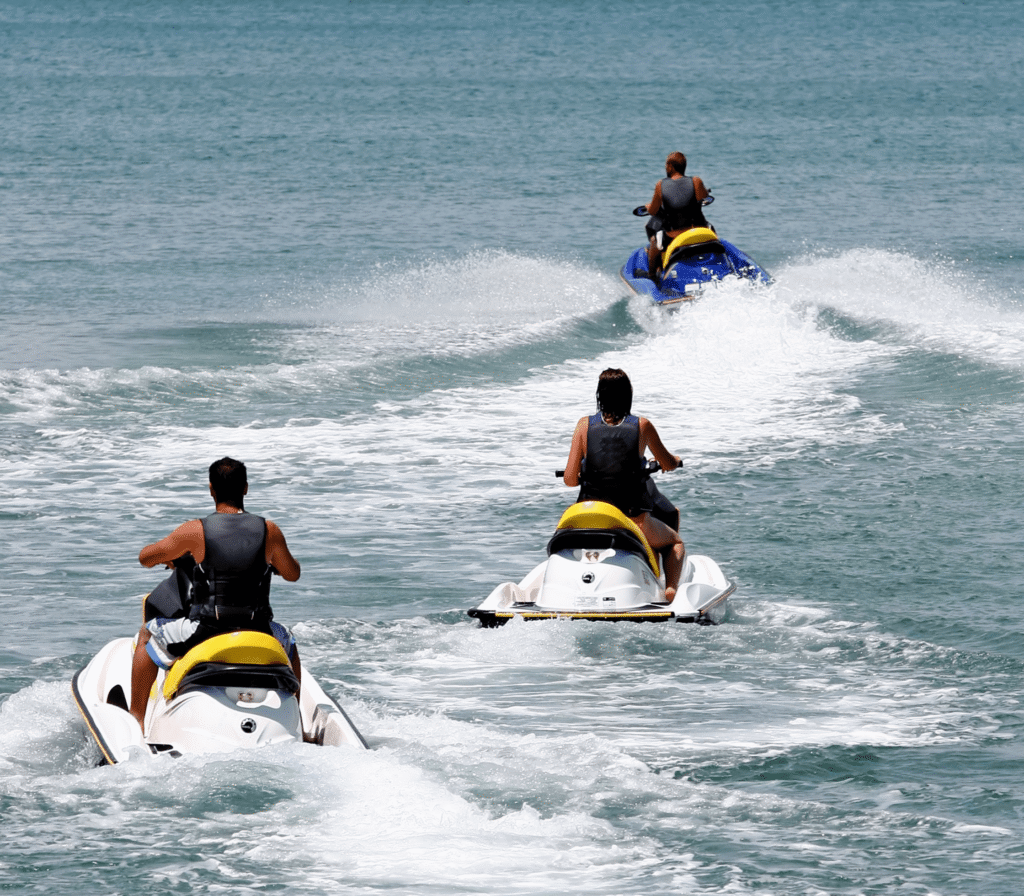 Two Jet Skis Riding Side By Side On The Water