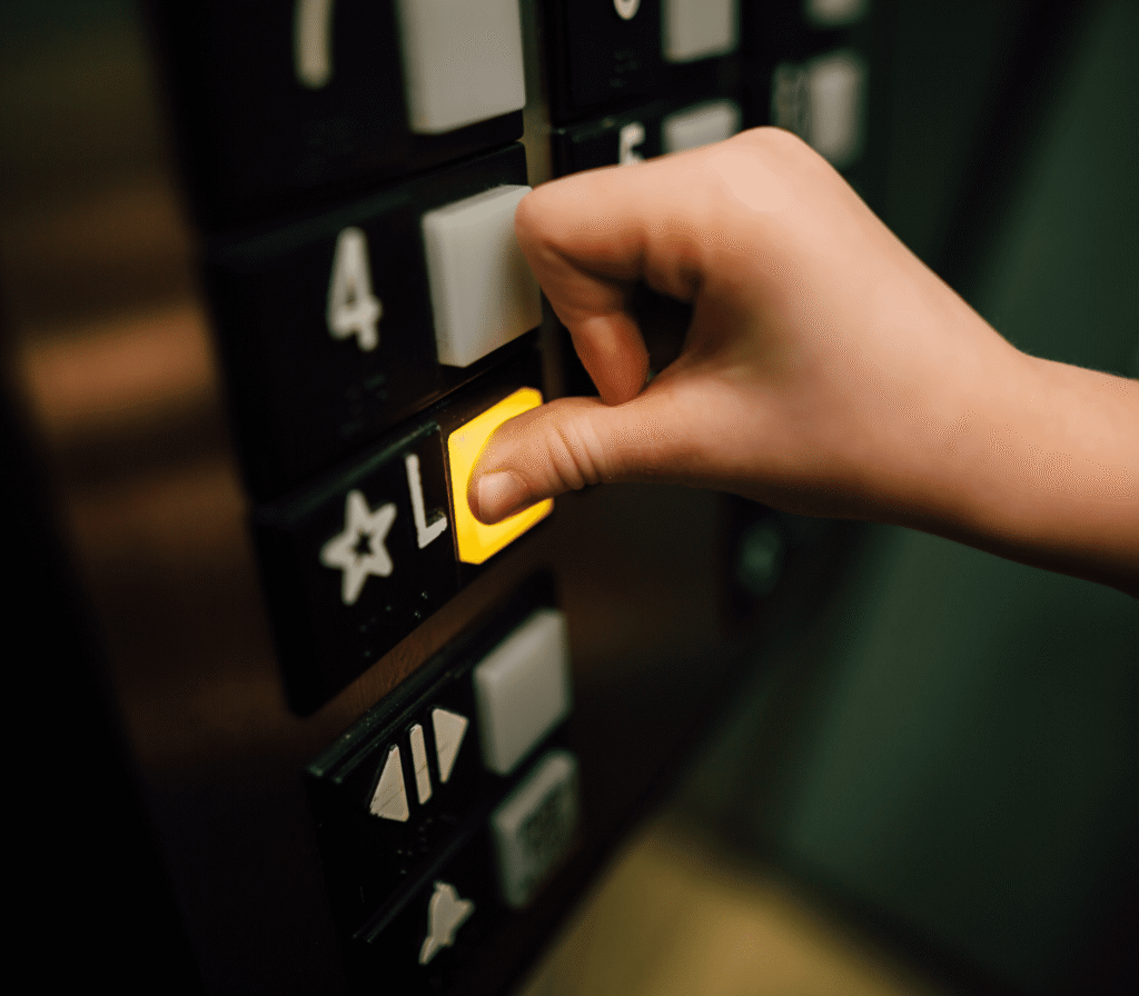 Hand Pressing An Elevator Button
