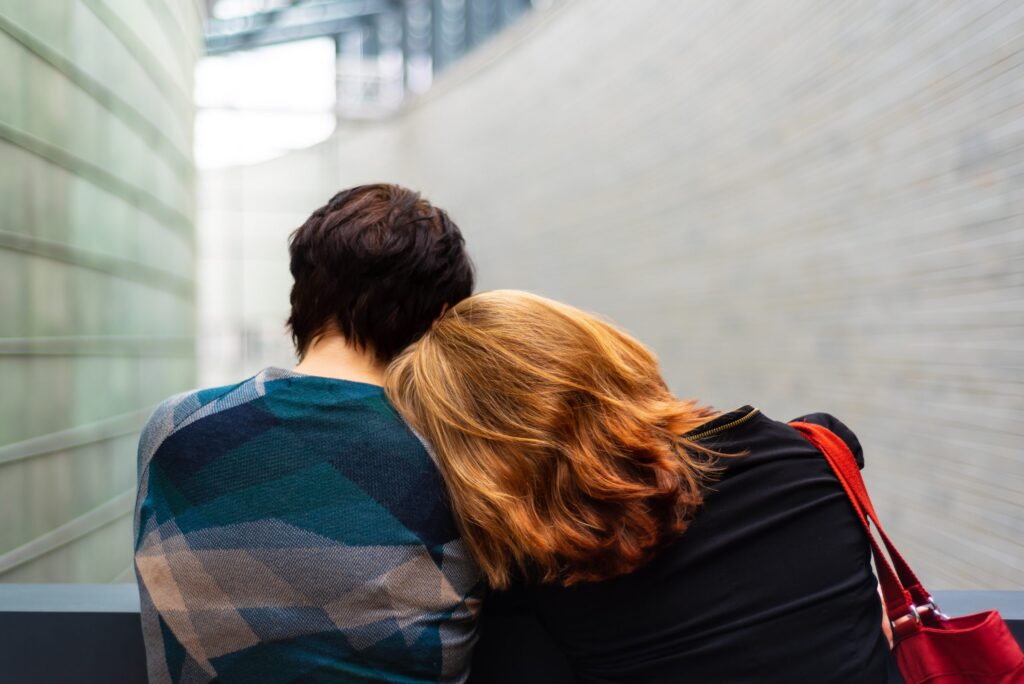 Couple Sitting Closely Together Outdoors