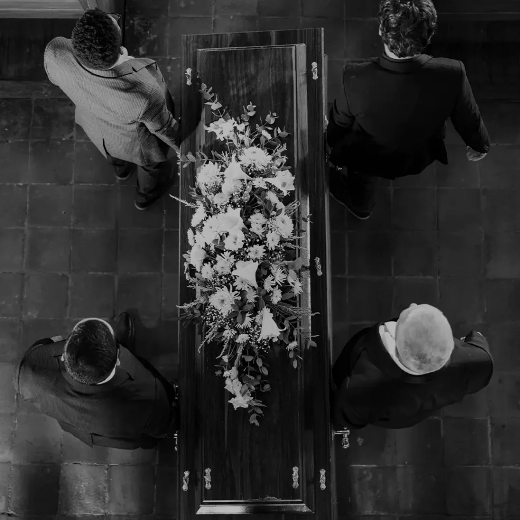 Aerial View Of A Casket With Flowers At A Funeral