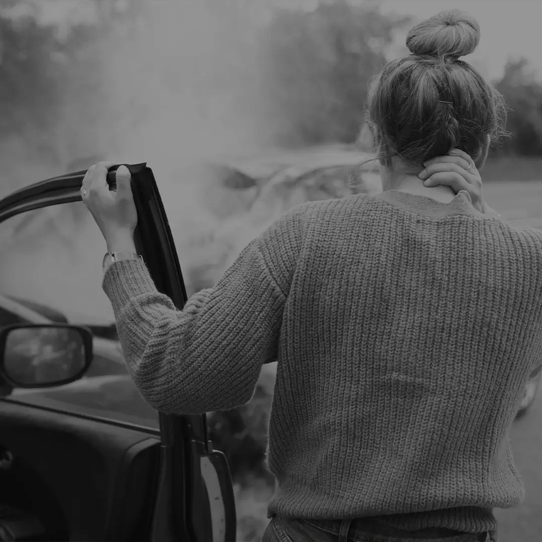 Person On The Phone Standing By A Damaged Car