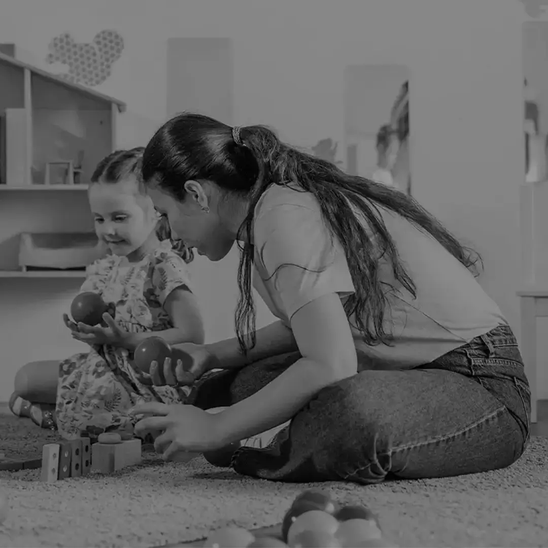 Woman Playing With A Toddler On The Floor