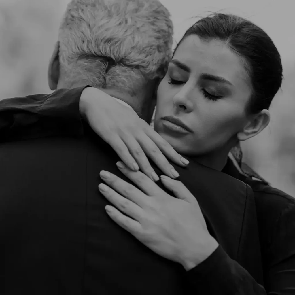 Woman Being Comforted With A Hand On Her Face