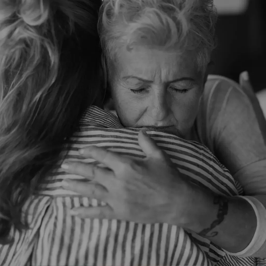 Woman Crying While Being Comforted, Black And White