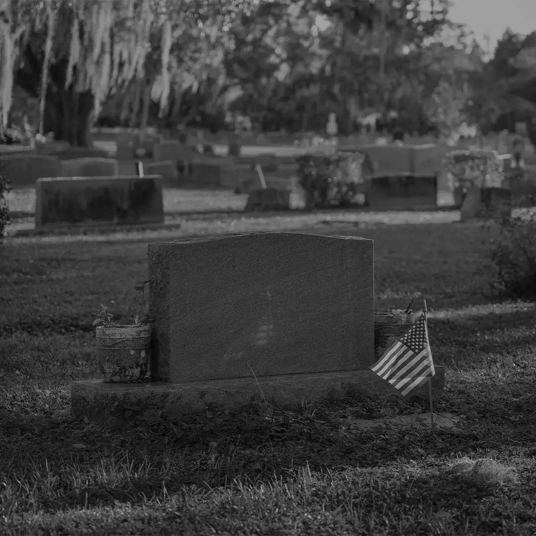 Single Grave Marker With A Small Flag In A Cemetery