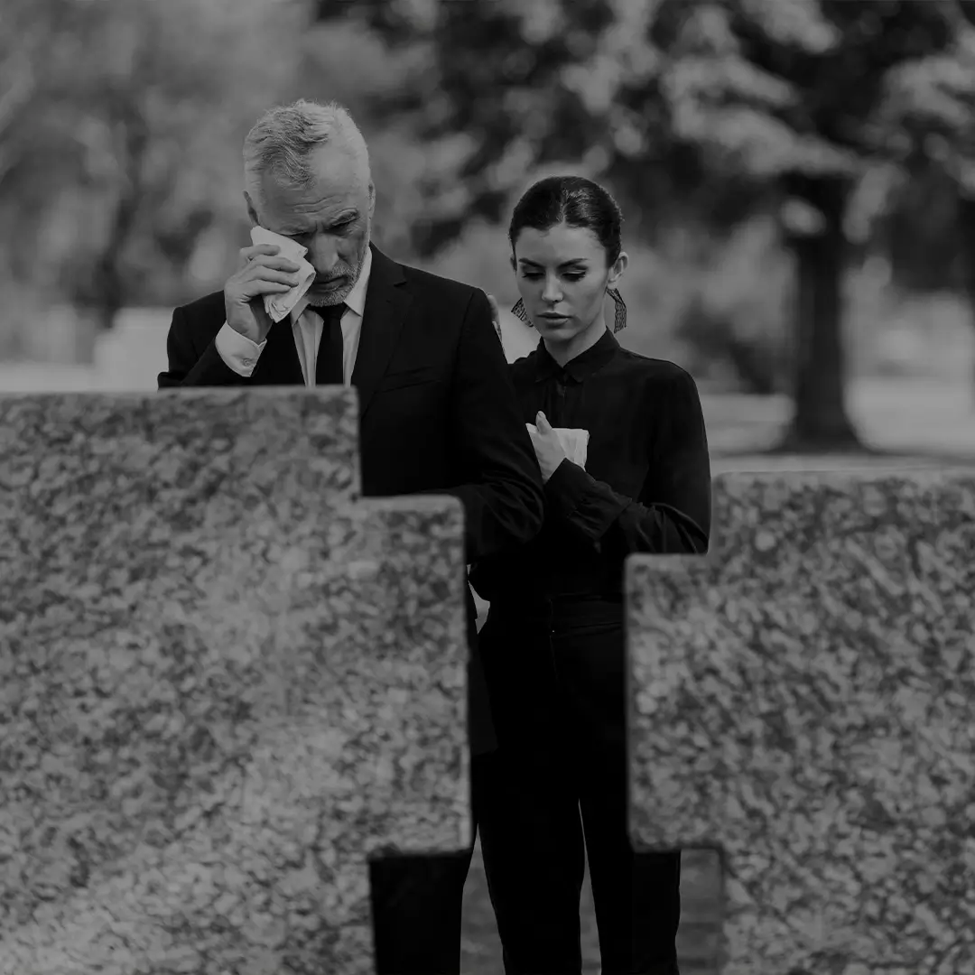 Man Mourning Alone At A Graveside
